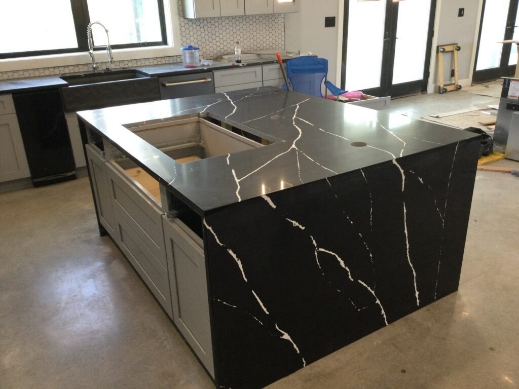 Black quartz waterfall island with white veining, Austin TX