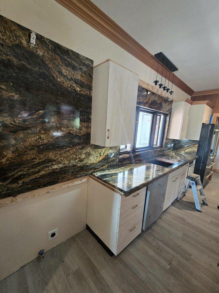 Dark brown and gold granite countertops with full-height backsplash, Austin TX kitchen