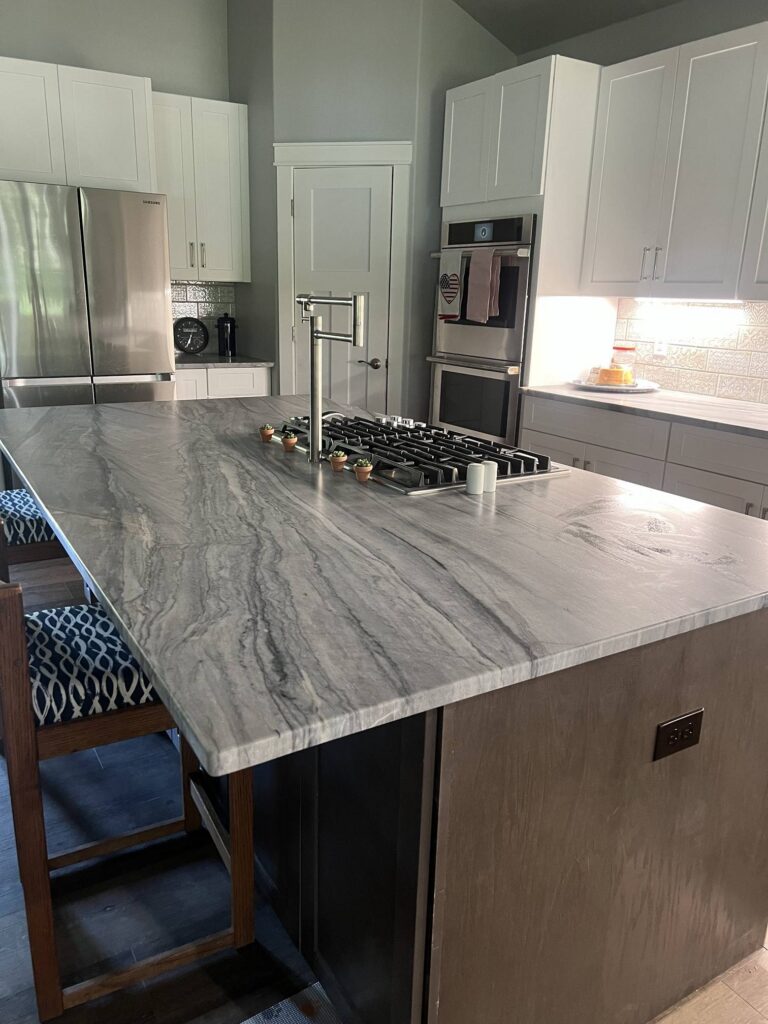 Gray quartzite kitchen island with cooktop and pot filler, Austin TX