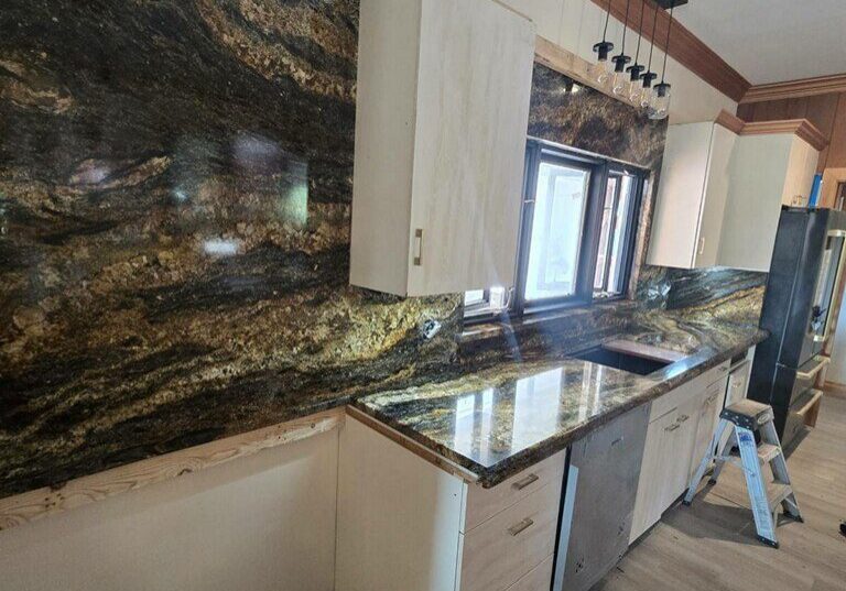 Dark brown and gold granite countertops with full-height backsplash, Austin TX kitchen